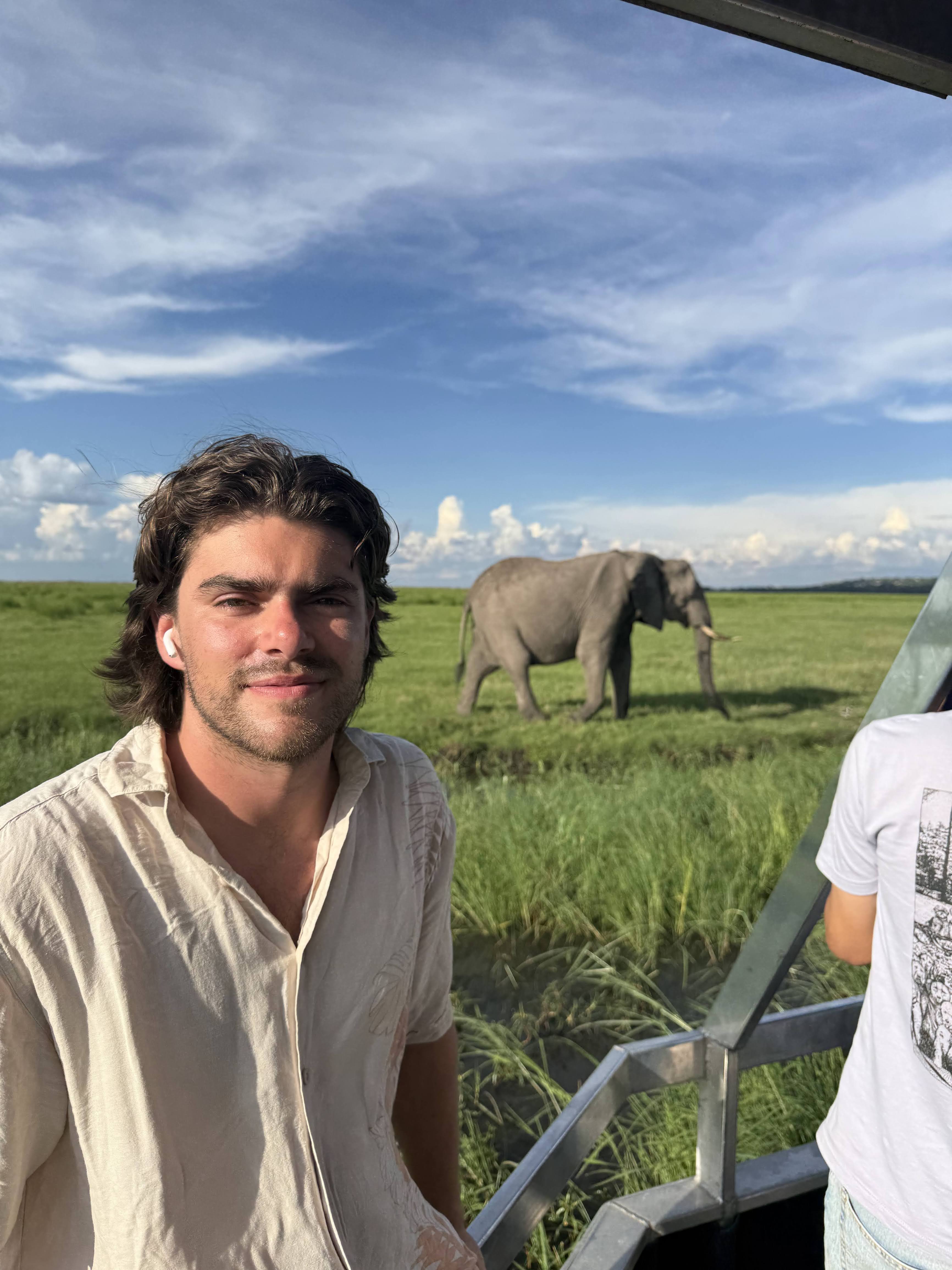Will Scott-Rodriguez at Chobe National Park, Botswana, with an elephant in the background